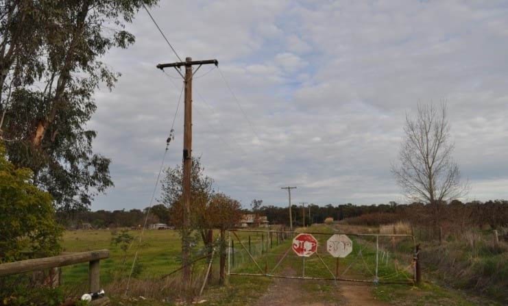 A photograph of a private aerial line on a rural, private road.