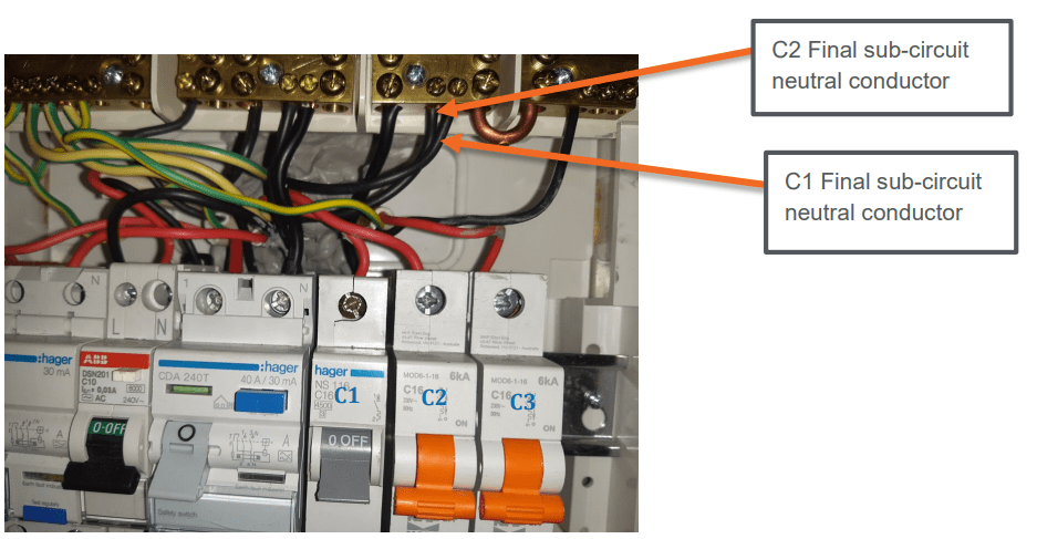 A photograph detailing netural conductors of final sub-circuits. Two arrows point to 'C1' and 'C2'. Both 'C1' and 'C2' are labelled as 