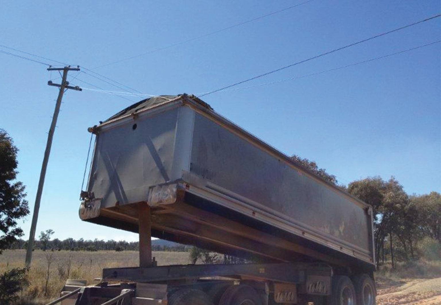 Tipper truck near powerline Tipper truck near powerline