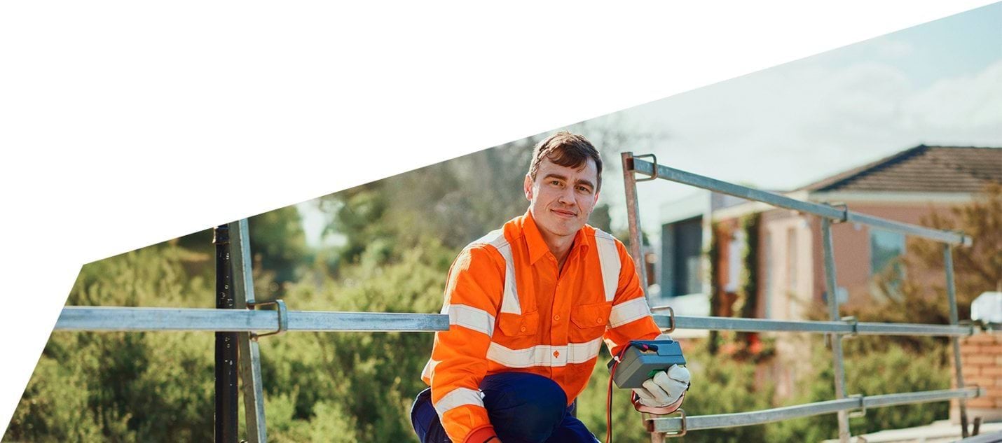 Image of an A Grade electrician servicing solar on a roof Image of an A Grade electrician servicing solar on a roof